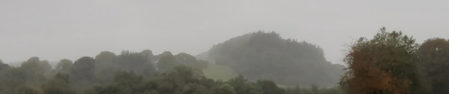 A view of mountains obscured by mist